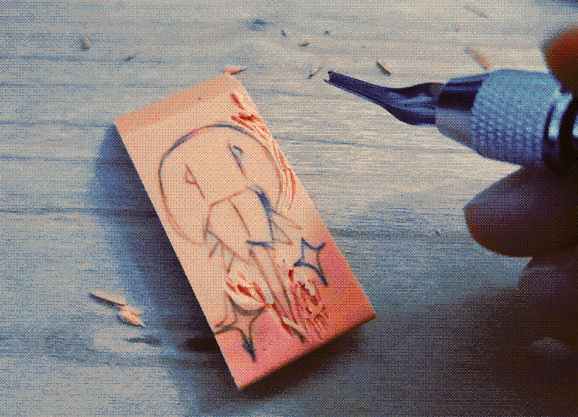 A picture of a half-carved eraser into the shape of a horseshoe crab.