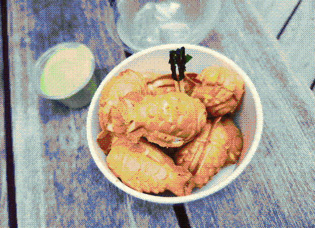 A photograph of a cup of small taiyaki, with matcha cream.